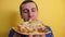 Piece Pizza . happy man eating a slice of pizza concept. male hungry eats a slice of pizza. slow motion video. pizza