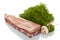 Piece of pork ribs, next to a bunch of dill and mushroom isolated on white