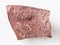 piece of raw red marble stone on white