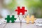 Piece of Red green and gold jigsaw puzzle On the old wood And green background. teamwork concept. symbol of association and