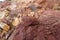 A piece of red shale sedimentary rock on nature background.