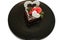 piece of romantic chocolate cake on black plate. Small baked cake decorated for Saint Valentines Day with love and heart mastic