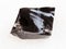 piece of rough Obsidian stone on white