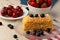 Piece of russian honey cake medovik served with berries