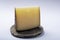 Piece of Spanish hard scheep milk cheese Manchego on grey stone plate isolated close up