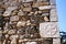 Piece of stone with sculptured symbol, detail from the exterior wall of an old house