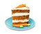 Piece of sweet carrot cake with delicious cream on plate