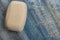 A piece of toilet soap on a wooden background. Frequent hand washing with soap is a prevention of COVID-19 infection. Close up