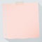 Piece of torn pink graph note paper with long shadow