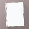 Piece of torn white blank lined notebook paper on dark striped diagonal background