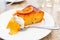 A piece of traditional greek orange cake on white plate. A mouth