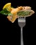 Piece of turkey stuffed with spinach decorated with lemon and parsley on a fork