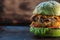 Piece of veggie burger. lettuce, cutlet vegetarian meat alternatives, mushrooms. rusty baking stick. wooden background. copyspace