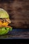 Piece of veggie burger. lettuce, the cutlet vegetarian meat alternatives. rusty baking stick. wooden background. copyspace