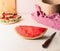 Piece of watermelon on white table at wall background with knife. Juicy refreshing summer food. Copy space