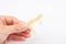 piece of wax with cannabis in hand on a white background close-up