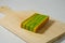 A piece of yellow-green lapis legit cake