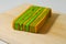 A piece of yellow-green lapis legit cake