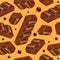 Pieces of aerated chocolate on a orange background
