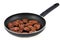 Pieces of beef meat cooked in a frying pan close-up on white background