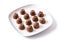 pieces of bonbons on white plate isolated