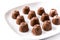 Pieces of bonbons on white plate isolated