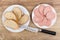 Pieces of bread, slices of sausages in white plate, knife