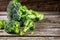 Pieces of broccoli, rustic style, old wooden background