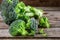 Pieces of broccoli, rustic style, old wooden background