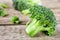 Pieces of broccoli, rustic style, old wooden background