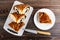 Pieces of bun with poppy on cutting board, knife, piece of bun o