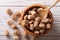 Pieces of cane sugar in a wooden bowl closeup. horizontal top view