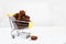 Pieces of chaga in a grocery cart on a light background. Health concept. Copy spaes