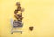 Pieces of chaga mushroom in a grocery cart on a yellow background. Healthy vegetarian food. Copy spaes