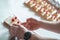 Pieces of cheesecake with hands, confectioner hands at work