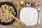 Pieces of chicken meat in frying pan, spices, empty plate