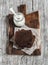 Pieces of chocolate cake and greek natural yogurt on a wooden cutting board
