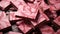 Pieces of chocolate with marbled pink pattern, closeup view