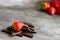 Pieces of chocolate with strawberries. Grey background. Copy space.