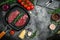 Pieces of cooked rump steak with spices served on grill pan. Steak of marbled beef black Angus. Raw beef ramp steak, top view