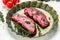 Pieces of cooked rump steak with spices served on old meat tray. Steak of marbled beef black Angus. Raw beef ramp steak, top view