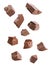 Pieces of delicious milk chocolate falling on background