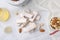 Pieces of delicious nutty nougat, nuts and honey on white table, flat lay