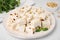 Pieces of delicious nutty nougat on plate, closeup