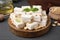 Pieces of delicious nutty nougat on wooden board, closeup