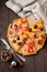 Pieces of different Greek pizzas with olives, Italian Margarita and Pepperoni on a dark wooden rustic background. Selective focus