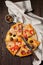 Pieces of different Greek pizzas with olives, Italian Margarita and Pepperoni on a dark wooden rustic background. Selective focus