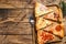 Pieces of different pizza various types. Wooden background. Top view. Copy space