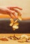 Pieces of dried fruit fall on the table from the unclenched hand