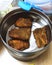 Pieces of Fish fry in a steel bowl or container